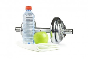 Dumbell, bottle, towel and green apple
